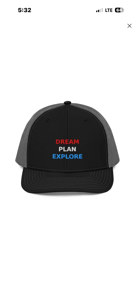 Black and gray trucker hat with Dream Plan Explore embroidered in red, white, and blue